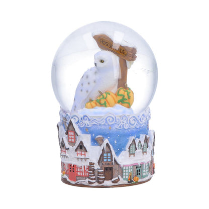 Harry Potter Hogsmeade Village snow globe by Nemesis Now, featuring detailed Hogwarts and Hogsmeade scene inside a glass globe.