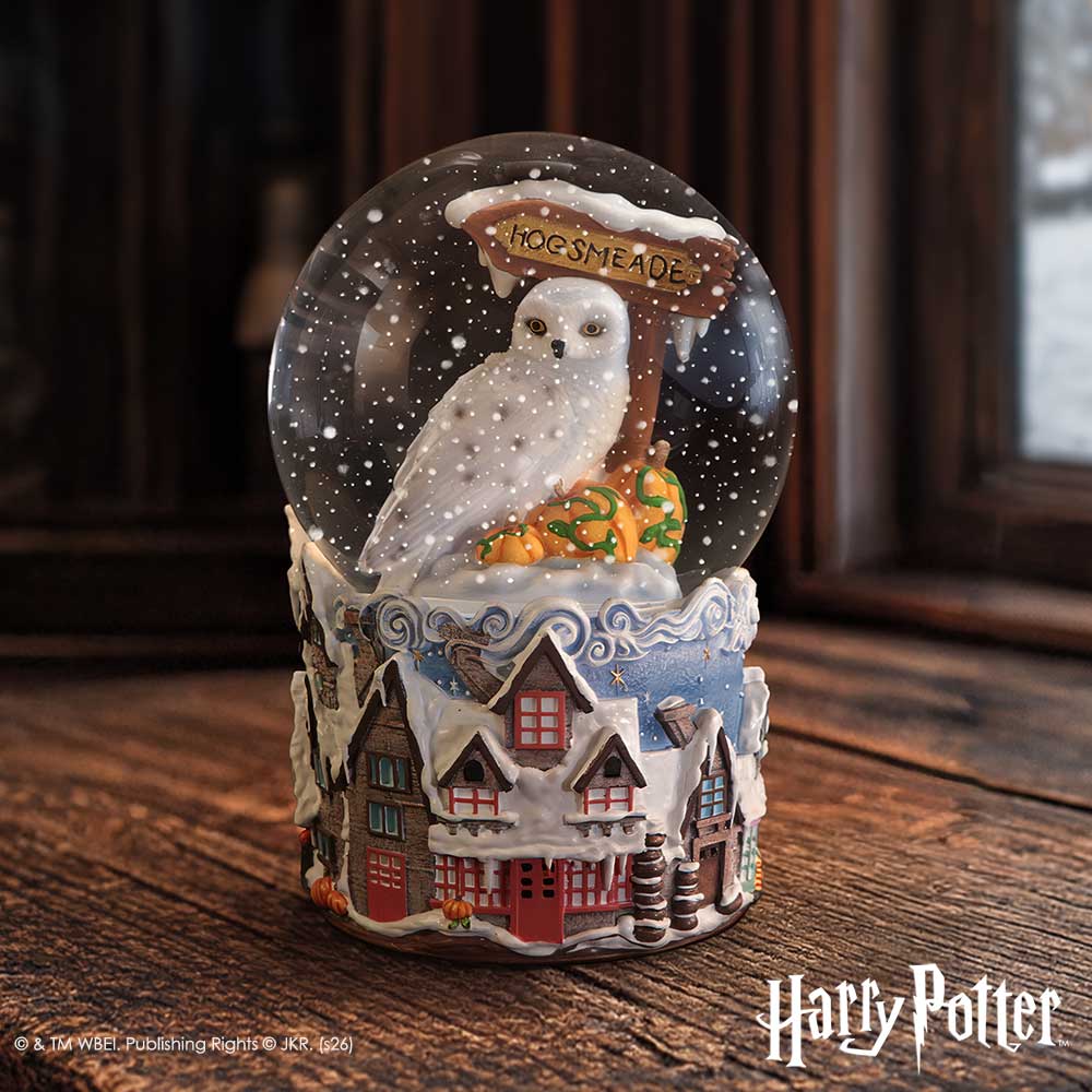 Harry Potter Hogsmeade Village snow globe by Nemesis Now, featuring detailed miniature scene inside a glass globe, 14.6cm tall.
