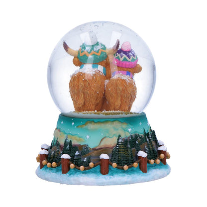 Winter Highland Cow snow globe by Nemesis Now, 13.7cm tall, featuring a Highland Cow figure inside a glass globe with snowy scene.