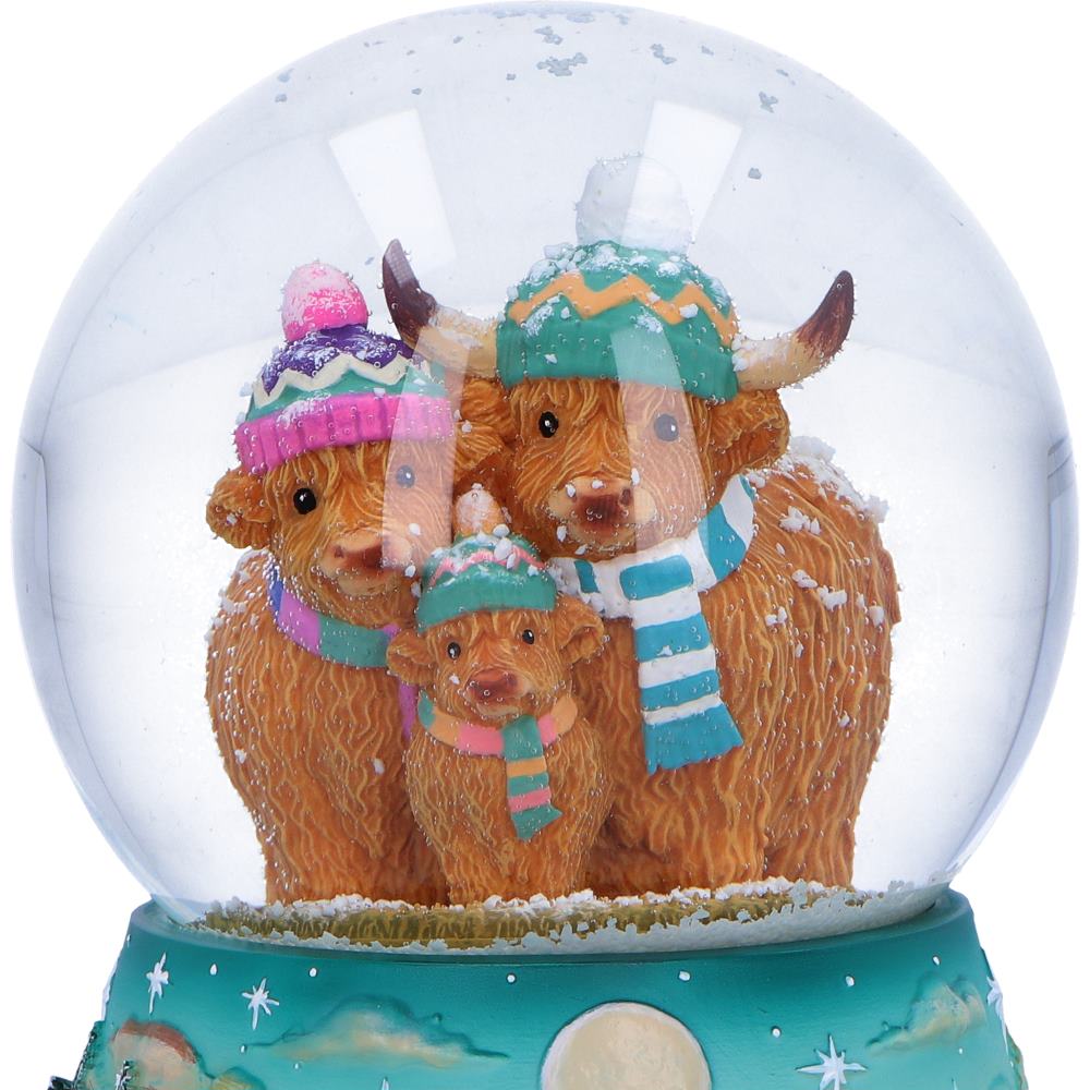 Winter Highland Cow snow globe by Nemesis Now featuring a detailed Highland Cow design inside a clear glass globe, 13.7cm tall.
