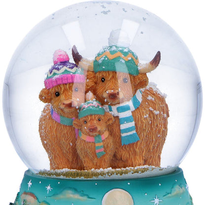Winter Highland Cow snow globe by Nemesis Now featuring a detailed Highland Cow design inside a clear glass globe, 13.7cm tall.