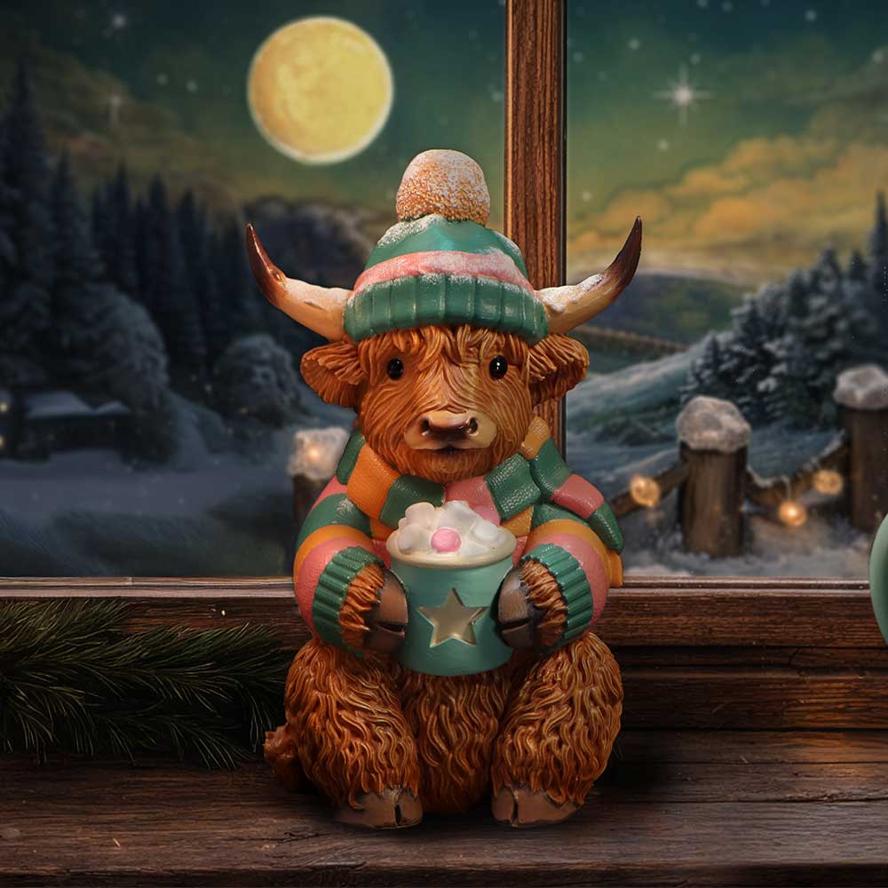Winter Highland Cow Hot Cocoa figurine by Nemesis Now, 12.3cm ceramic sculpture with a Highland cow holding a hot cocoa mug.