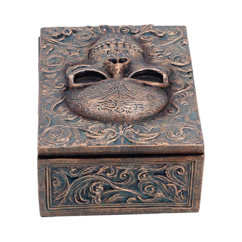 Small black box with intricate embossed design, labeled "Treasured Remains," by Nemesis Now, measuring 5.6cm.